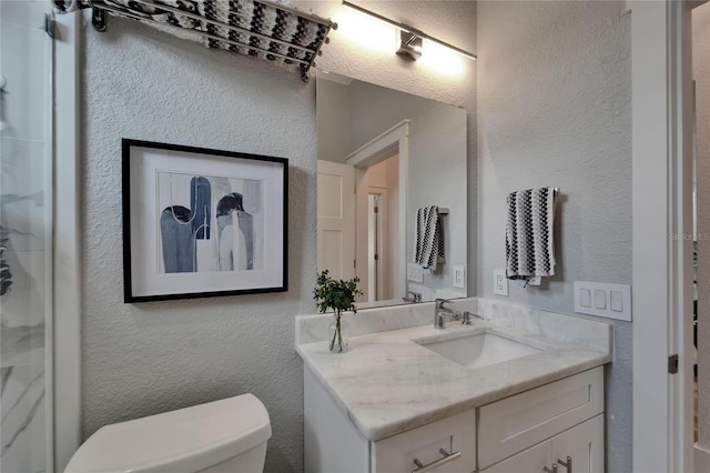 9004 Selph Rd, Lakeland, FL 33810 - full bath featuring toilet, vanity, a textured wall, and walk in shower