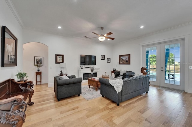 9004 Selph Rd, Lakeland, FL 33810 - living room featuring arched walkways, recessed lighting, ornamental molding, and light wood-type flooring