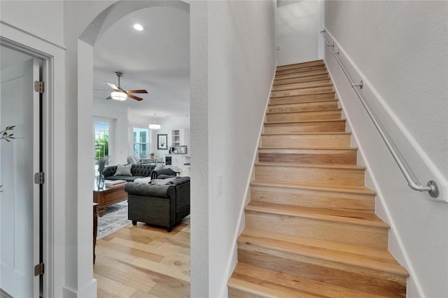 9004 Selph Rd, Lakeland, FL 33810 - staircase featuring arched walkways, wood finished floors, and a ceiling fan