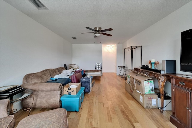9004 Selph Rd, Lakeland, FL 33810 - living area featuring light wood-style floors, visible vents, a textured ceiling, and ceiling fan