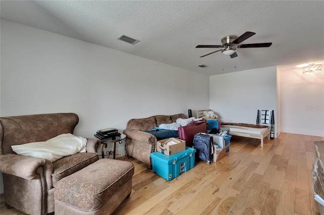 9004 Selph Rd, Lakeland, FL 33810 - living area featuring visible vents, a ceiling fan, wood finished floors, and a textured ceiling
