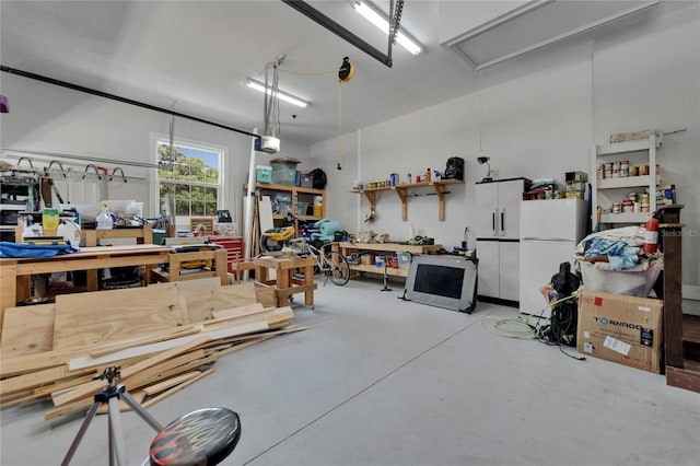 9004 Selph Rd, Lakeland, FL 33810 - garage with a garage door opener, freestanding refrigerator, and a workshop area