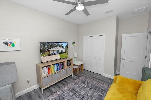 living area with visible vents, baseboards, ceiling fan, and wood finished floors