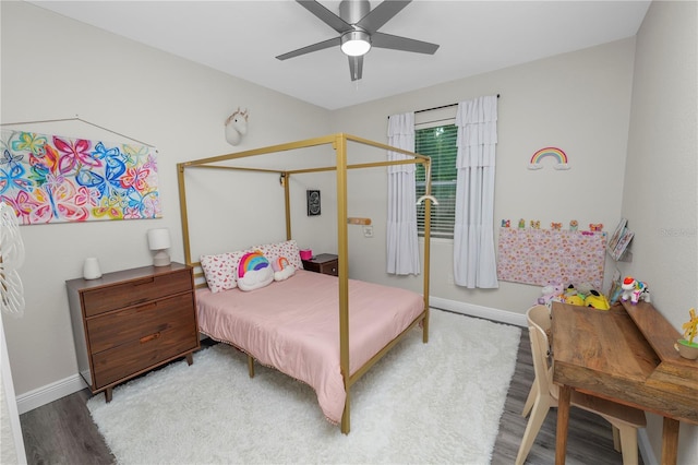 bedroom with baseboards, a ceiling fan, and wood finished floors