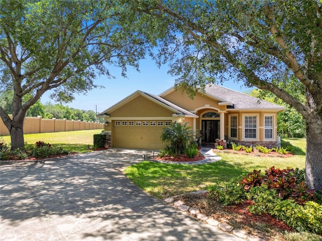 view of front of house with stone siding, driveway, an attached garage, and stucco siding
