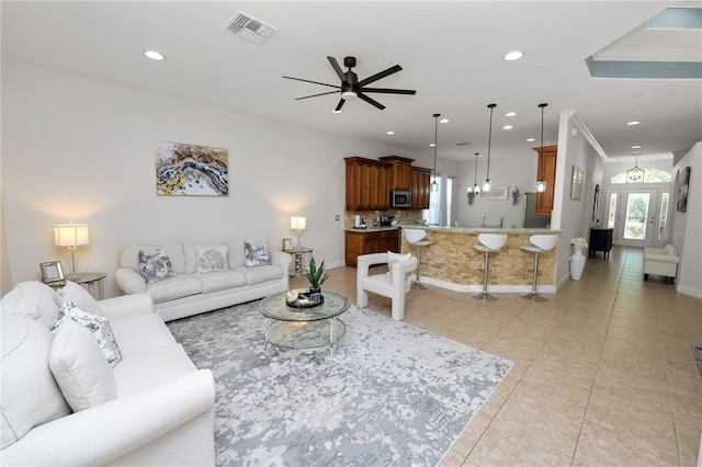 living area with recessed lighting, light tile patterned floors, a ceiling fan, and baseboards