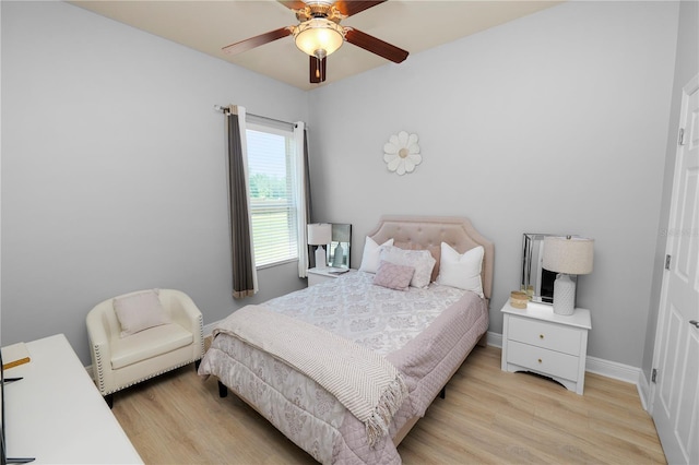 bedroom with light wood finished floors, baseboards, and ceiling fan