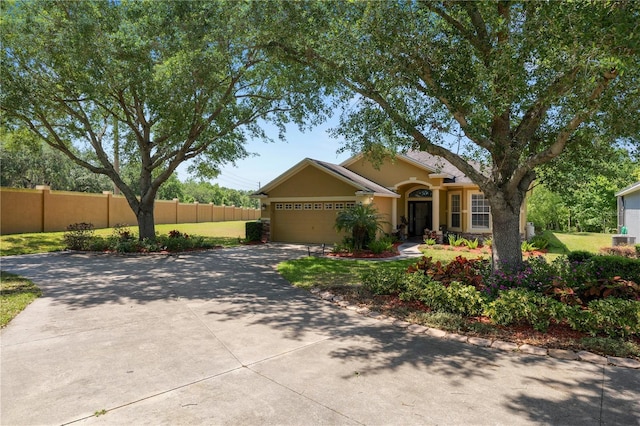 view of front of house featuring driveway, stucco siding, and an attached garage