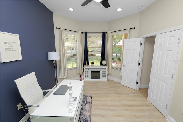 office space featuring a ceiling fan, light wood finished floors, recessed lighting, and baseboards