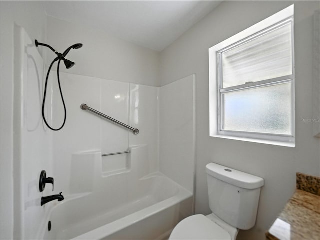 bathroom with shower / bathing tub combination and toilet