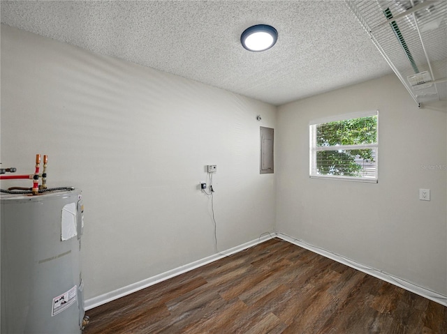 laundry room with baseboards, water heater, a textured ceiling, and wood finished floors