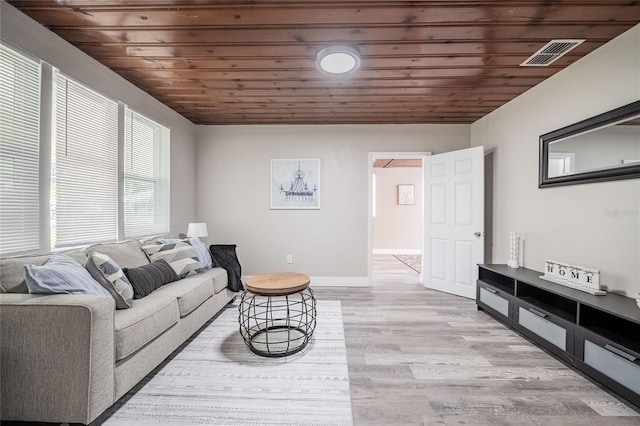 living area featuring light wood-style floors, visible vents, wood ceiling, and baseboards