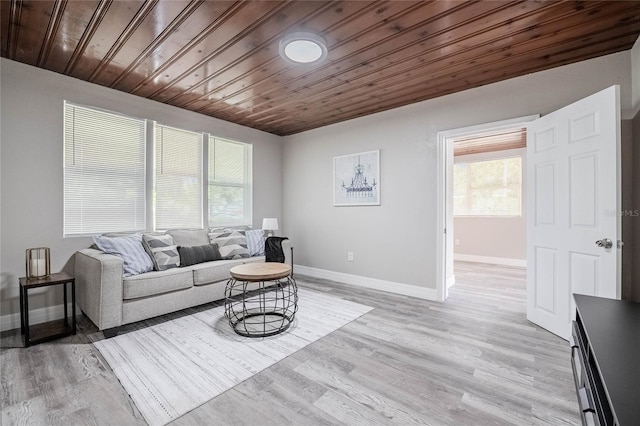 living area with baseboards, plenty of natural light, and wood ceiling