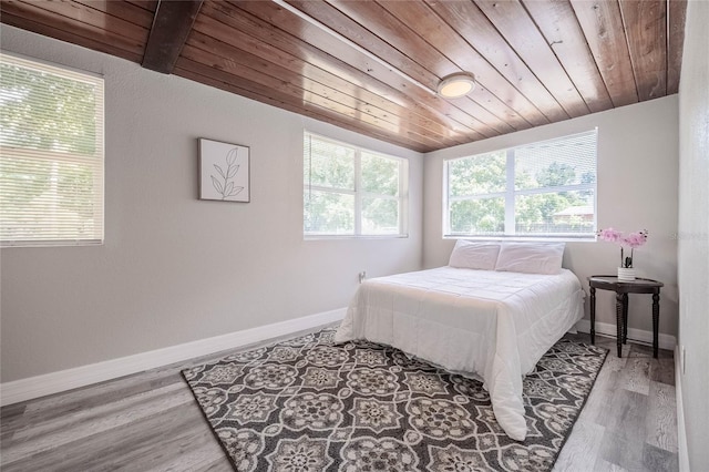 bedroom featuring wooden ceiling, wood finished floors, baseboards, and lofted ceiling