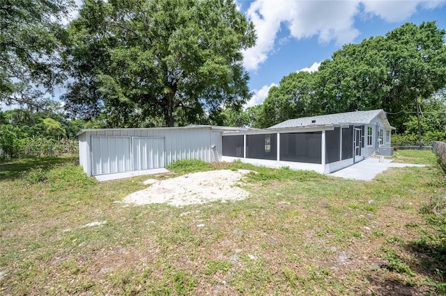 view of yard featuring a sunroom, central AC unit, and fence