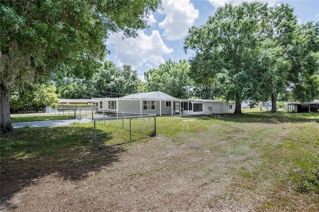 view of yard with fence, a gate, and concrete driveway