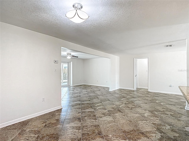 4921 Marlin Dr, New Port Richey, FL 34652 - unfurnished room featuring visible vents, baseboards, a ceiling fan, and a textured ceiling