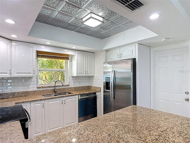 4921 Marlin Dr, New Port Richey, FL 34652 - kitchen featuring a sink, white cabinetry, stainless steel refrigerator with ice dispenser, and dishwasher