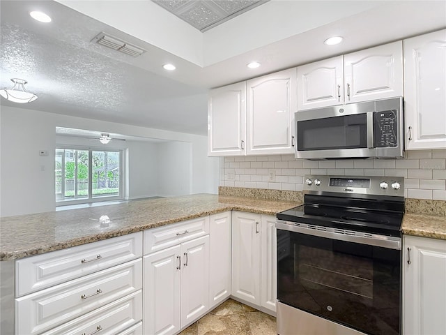 4921 Marlin Dr, New Port Richey, FL 34652 - kitchen with light stone counters, recessed lighting, visible vents, decorative backsplash, and stainless steel appliances