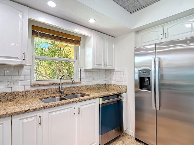 4921 Marlin Dr, New Port Richey, FL 34652 - kitchen with stainless steel fridge with ice dispenser, dishwasher, white cabinetry, and a sink