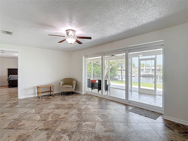 4921 Marlin Dr, New Port Richey, FL 34652 - sitting room featuring visible vents, baseboards, a ceiling fan, and a textured ceiling