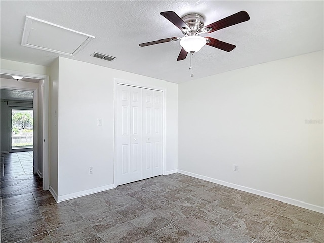4921 Marlin Dr, New Port Richey, FL 34652 - unfurnished bedroom featuring visible vents, baseboards, a textured ceiling, and stone finish flooring