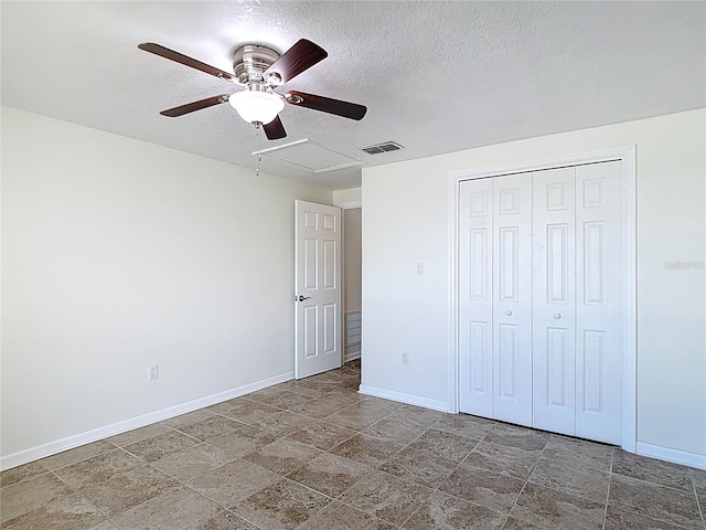 4921 Marlin Dr, New Port Richey, FL 34652 - unfurnished bedroom featuring a closet, baseboards, stone finish floor, visible vents, and ceiling fan