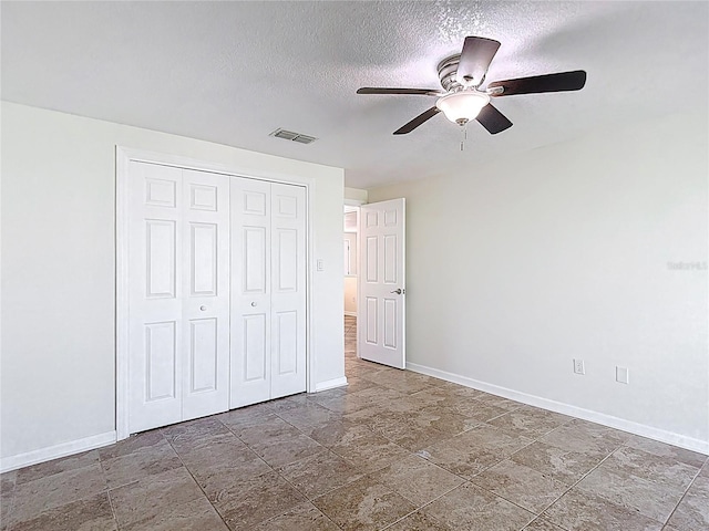4921 Marlin Dr, New Port Richey, FL 34652 - unfurnished bedroom with visible vents, baseboards, a closet, ceiling fan, and a textured ceiling
