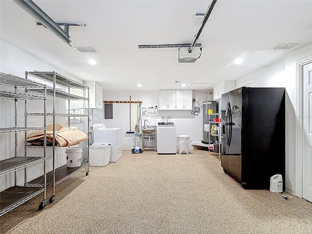 4921 Marlin Dr, New Port Richey, FL 34652 - interior space featuring electric water heater, recessed lighting, washing machine and dryer, and a garage