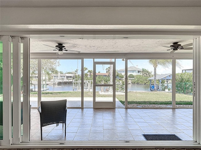 4921 Marlin Dr, New Port Richey, FL 34652 - entryway featuring tile patterned floors, ceiling fan, plenty of natural light, and a water view