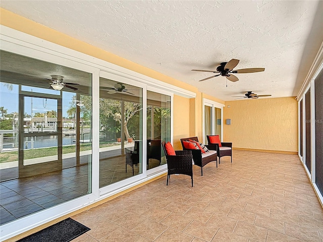 4921 Marlin Dr, New Port Richey, FL 34652 - sunroom / solarium featuring a water view, a textured ceiling, and ceiling fan
