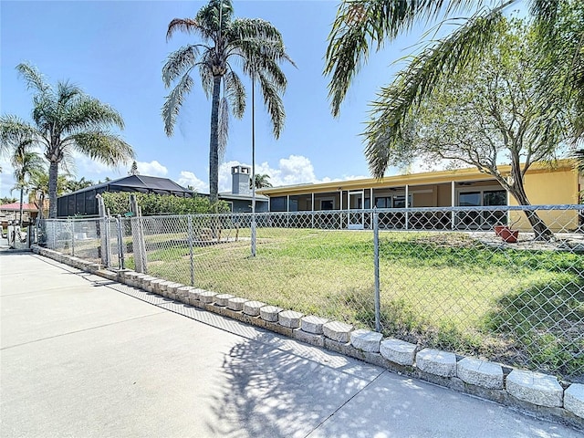4921 Marlin Dr, New Port Richey, FL 34652 - view of front of property featuring fence, a front lawn, and a gate