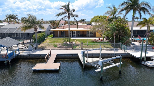 4921 Marlin Dr, New Port Richey, FL 34652 - dock area with boat lift, a yard, a fenced backyard, and a water view