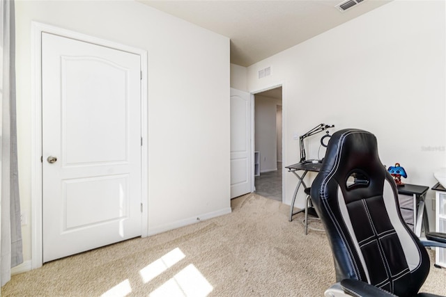 office area featuring baseboards, visible vents, and carpet