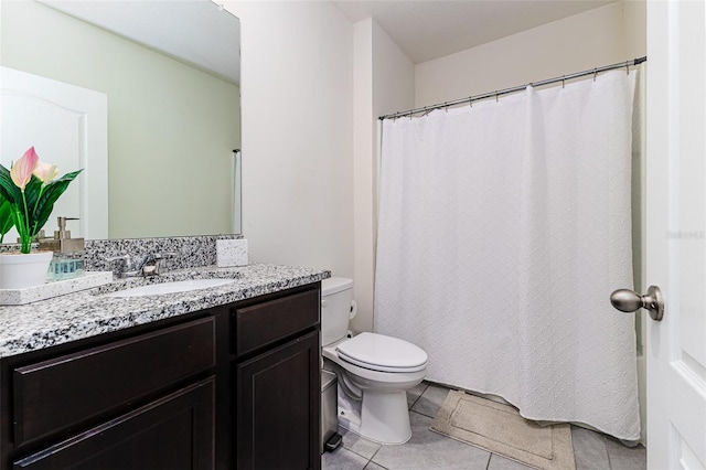 bathroom featuring tile patterned floors, vanity, and toilet