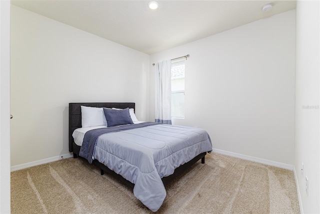carpeted bedroom featuring baseboards