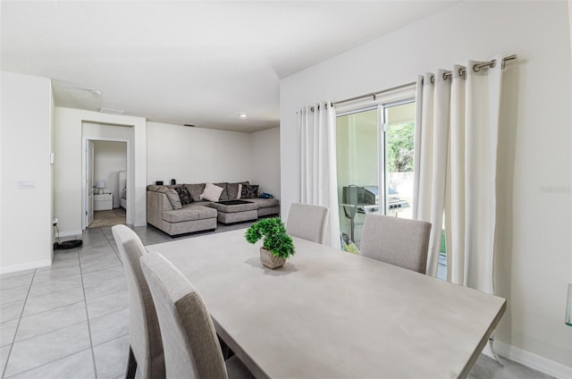 dining area featuring baseboards and light tile patterned floors