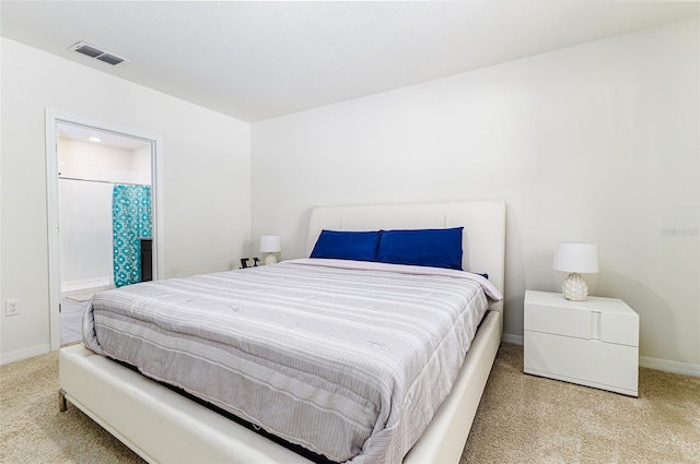 carpeted bedroom with baseboards and visible vents