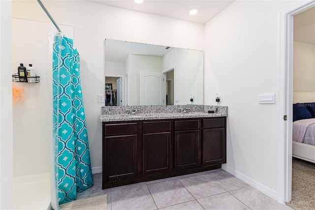 ensuite bathroom featuring a shower with shower curtain, ensuite bath, tile patterned flooring, and baseboards