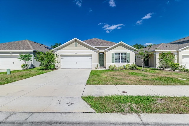 ranch-style home featuring stucco siding, an attached garage, driveway, and a front lawn