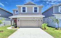 traditional home featuring a garage and concrete driveway