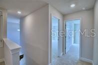 corridor with recessed lighting and baseboards