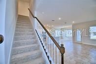 stairs with baseboards and recessed lighting