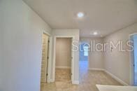 hallway with recessed lighting and baseboards