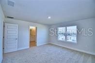 unfurnished bedroom featuring baseboards and carpet floors