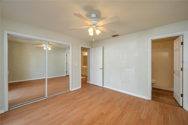 6315 Conductor Ct, Lakeland, FL 33813 - unfurnished bedroom with ensuite bathroom, a closet, light wood finished floors, baseboards, and visible vents