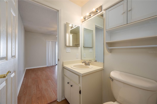 6315 Conductor Ct, Lakeland, FL 33813 - half bath featuring toilet, vanity, wood finished floors, and baseboards