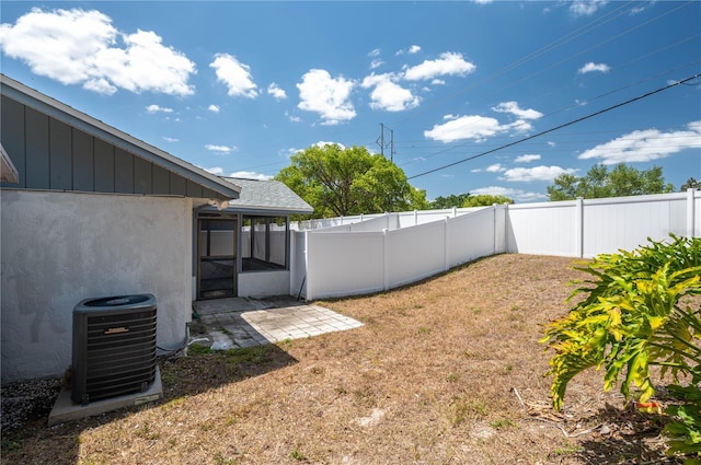 6315 Conductor Ct, Lakeland, FL 33813 - view of yard with a fenced backyard, a sunroom, and central air condition unit