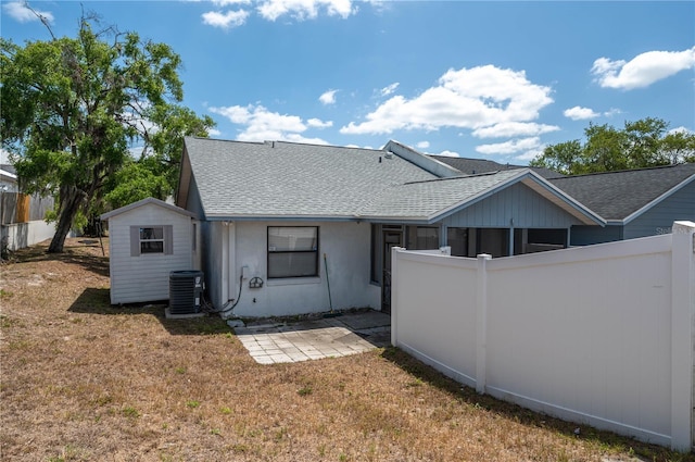 6315 Conductor Ct, Lakeland, FL 33813 - back of property featuring roof with shingles, fence, a patio area, and a shed