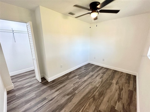 2527 Dons Pl, Lakeland, FL 33801 - unfurnished bedroom with dark wood-style flooring, baseboards, a ceiling fan, and a closet